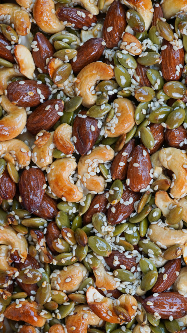 Golden nut and seed cluster bites broken into crunchy chunks on baking tray