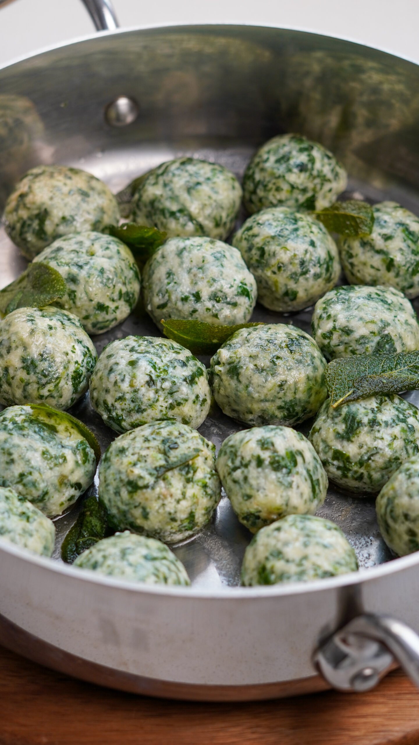 Pan full of handmade gnudi dumplings with a few sage leaves, ready to serve – traditional Tuscan gnudi recipe