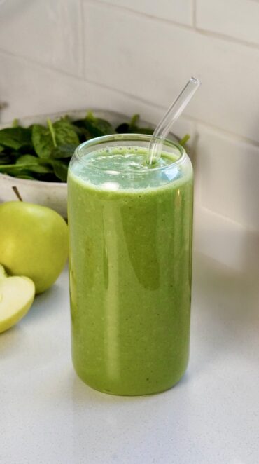 Healthy super green smoothie in a glass with spinach and grapes